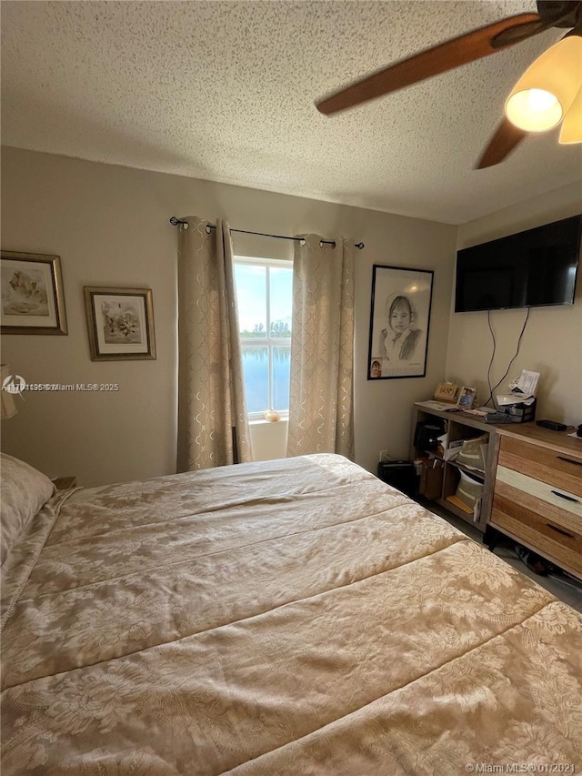 8240 SW 210th St Unit 214, Cutler Bay, FL 33189 - bedroom featuring a textured ceiling and ceiling fan