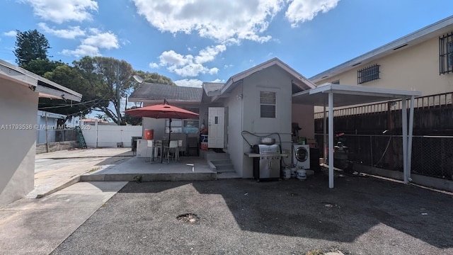 248 SW 18th Ct, Miami, FL 33135 - back of property featuring a fenced backyard, stucco siding, and a patio area