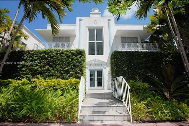 1751 James Ave Unit 101, Miami Beach, FL 33139 - view of front of home featuring french doors, a balcony, and stucco siding