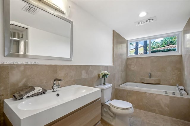 4050 NE 25th Ave, Lighthouse Point, FL 33064 - bathroom with tile patterned flooring, vanity, toilet, tile walls, and a bath
