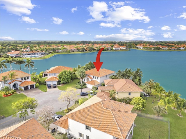 birds eye view of property featuring a water view and a residential view