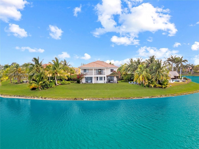 view of swimming pool with a lawn and a water view