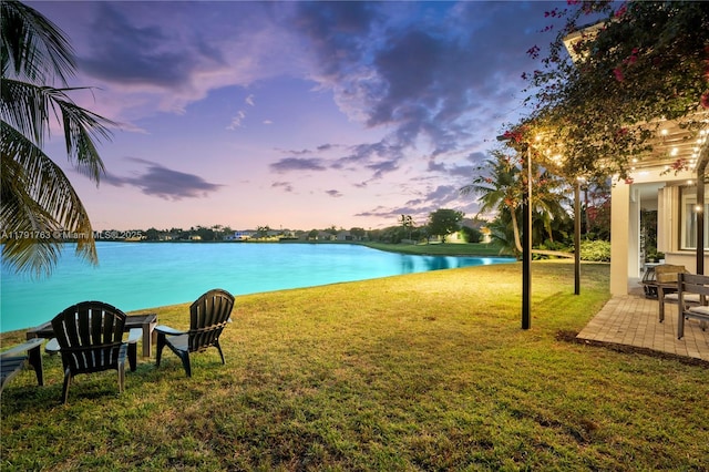 view of yard with a water view and a patio area