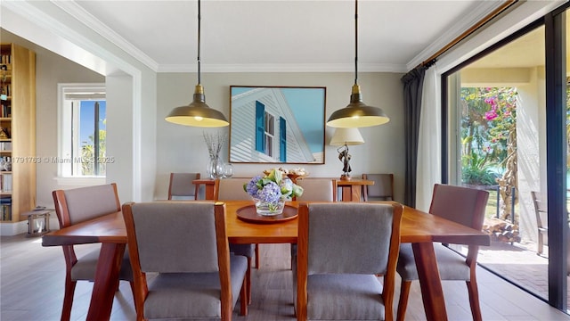 dining room featuring ornamental molding and wood finished floors
