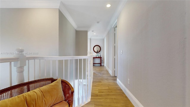 hallway featuring light wood-style floors, ornamental molding, baseboards, and recessed lighting