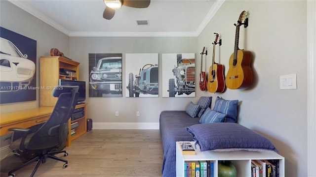 office featuring crown molding, baseboards, wood finished floors, and visible vents