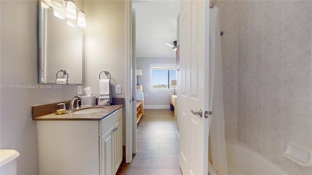 full bathroom with vanity, ornamental molding, wood finished floors, and shower / tub combo with curtain