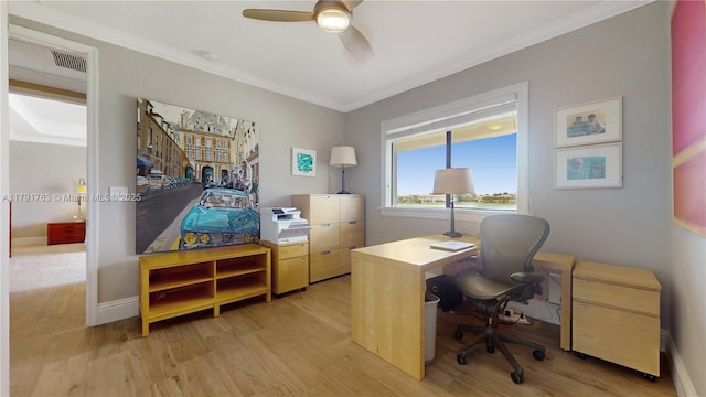 office space with light wood-type flooring, a ceiling fan, visible vents, and ornamental molding