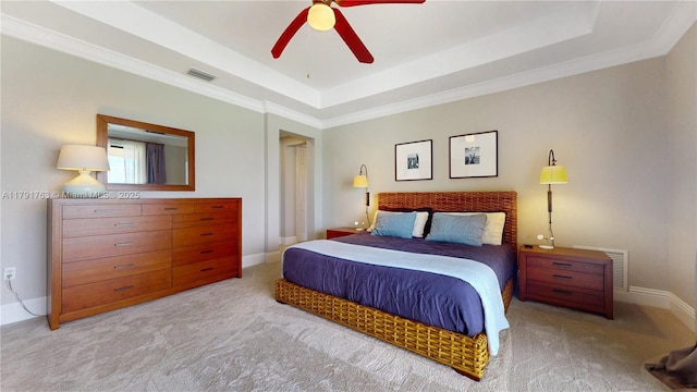 carpeted bedroom featuring a raised ceiling, ornamental molding, baseboards, and visible vents