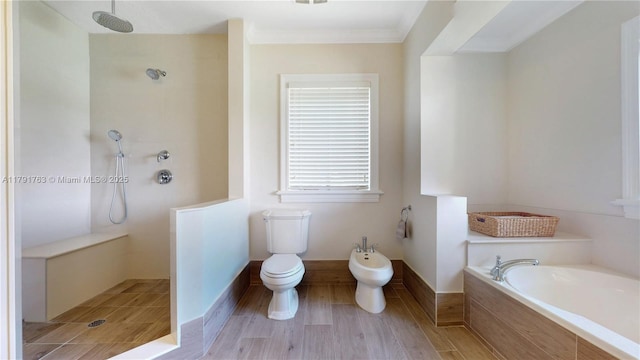 bathroom with walk in shower, toilet, ornamental molding, a bidet, and a garden tub