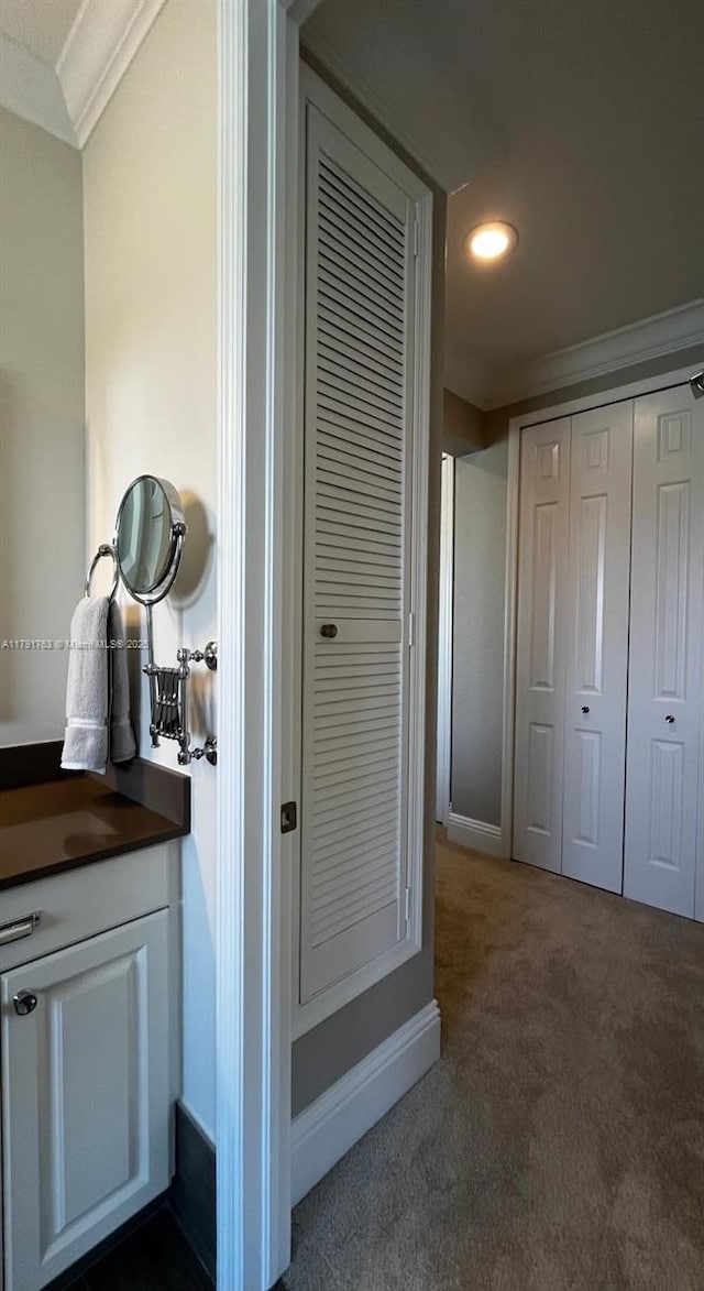 bathroom featuring recessed lighting, ornamental molding, and vanity