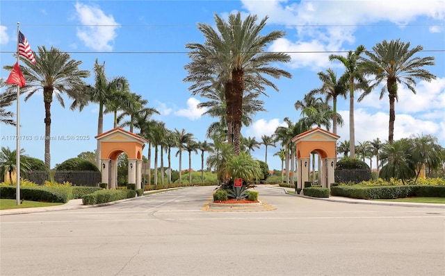view of street with a gate and curbs