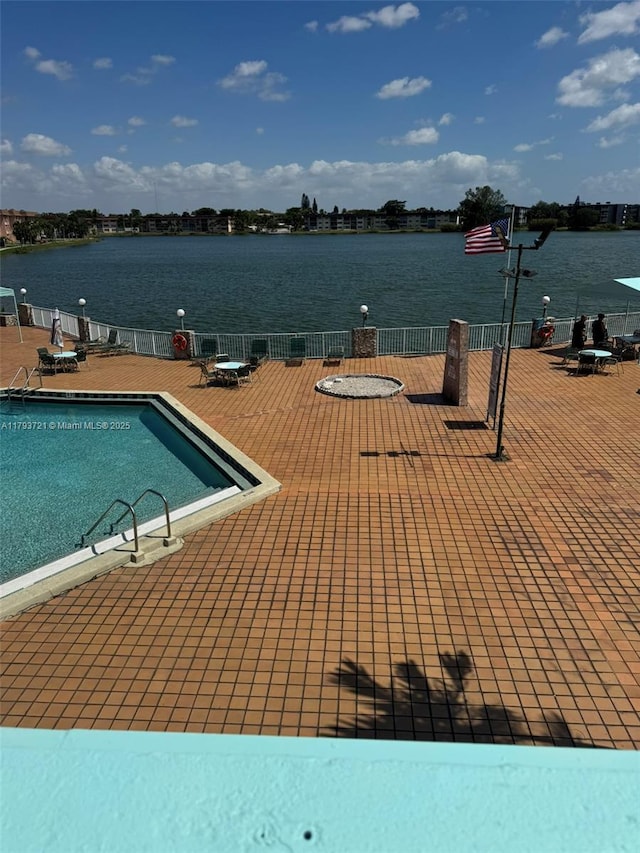 18555 NE 14th Ave Unit 602, Miami, FL 33179 - pool with a water view, fence, and a patio area