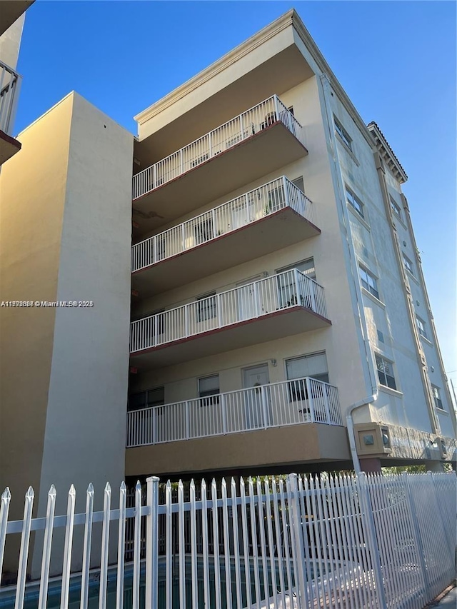 view of building exterior featuring fence