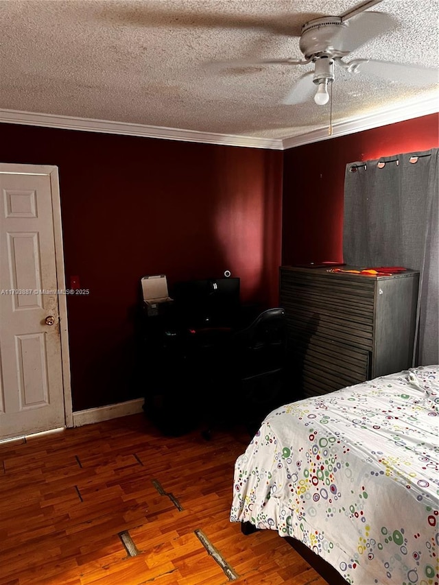 bedroom with crown molding, a ceiling fan, a textured ceiling, and wood finished floors