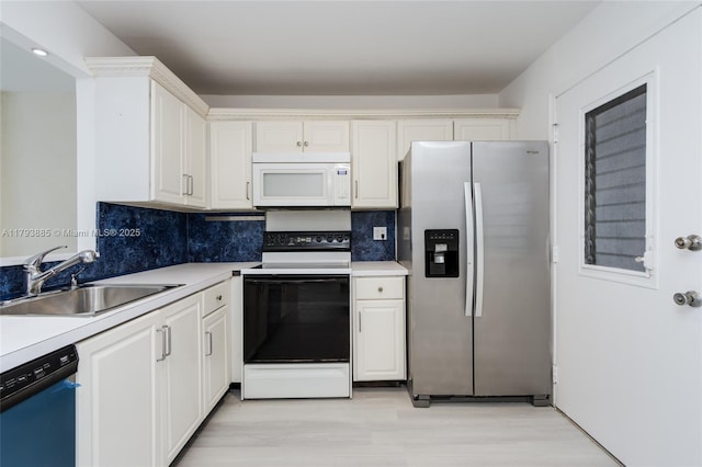 3600 NE 170th St Unit D-112, North Miami Beach, FL 33160 - kitchen featuring dishwashing machine, white microwave, stainless steel refrigerator with ice dispenser, electric range oven, and a sink