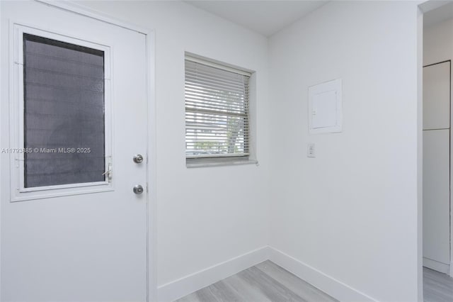3600 NE 170th St Unit D-112, North Miami Beach, FL 33160 - doorway to outside featuring light wood-type flooring and baseboards
