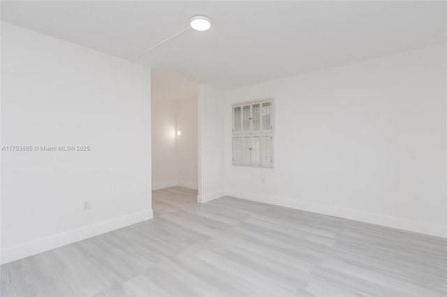 3600 NE 170th St Unit D-112, North Miami Beach, FL 33160 - spare room featuring baseboards and light wood-type flooring