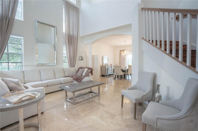 15852 SW 15th St, Davie, FL 33326 - living room with an inviting chandelier, arched walkways, marble finish floor, and a towering ceiling
