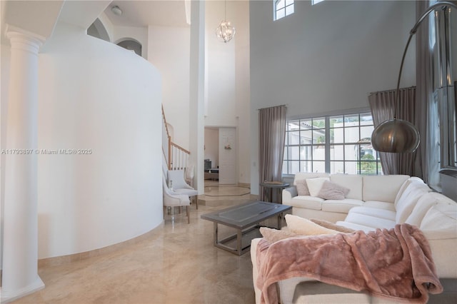 15852 SW 15th St, Davie, FL 33326 - living room with stairway, baseboards, a high ceiling, and decorative columns