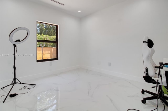 interior space with baseboards and marble finish floor