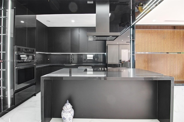 kitchen with dark cabinetry, a sink, modern cabinets, and marble finish floor