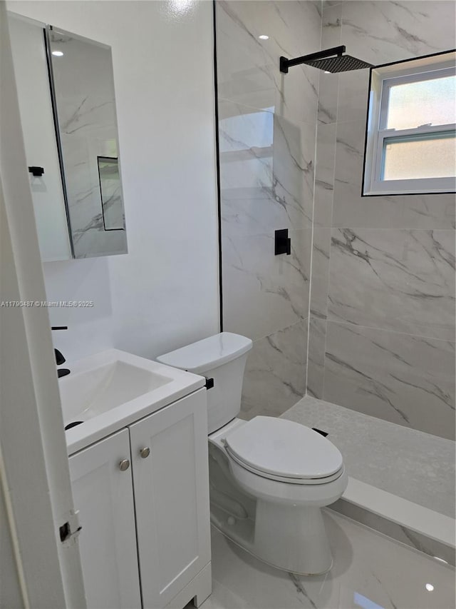 full bath featuring a marble finish shower, vanity, toilet, and marble finish floor