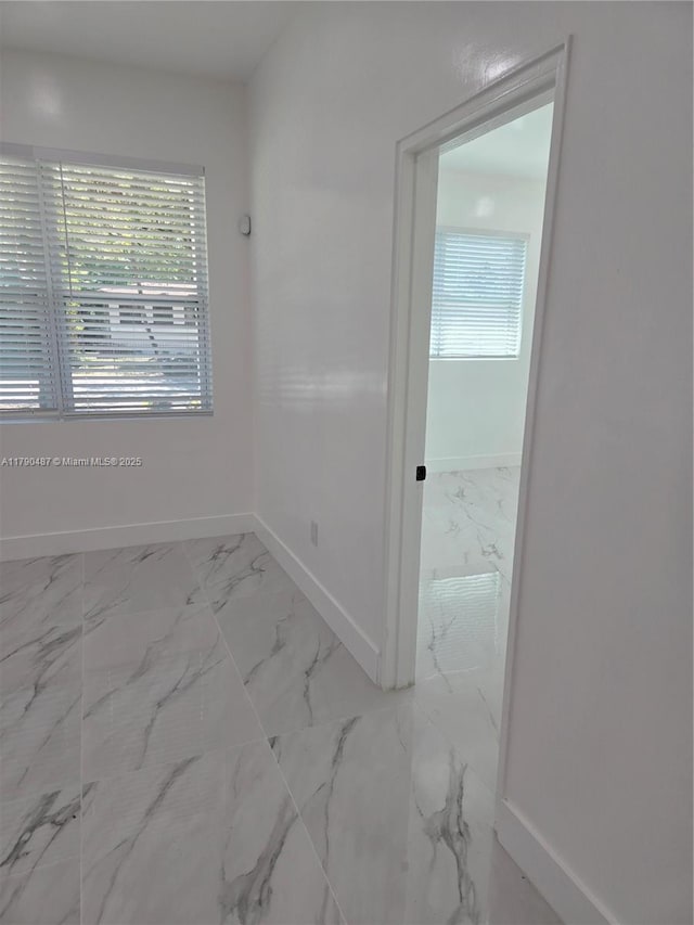 987 NE 145th St, North Miami, FL 33161 - spare room featuring marble finish floors, baseboards, and healthy amount of natural light