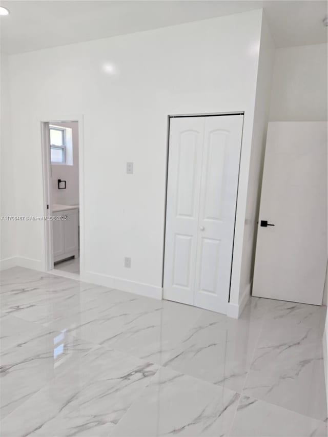 empty room with baseboards and marble finish floor