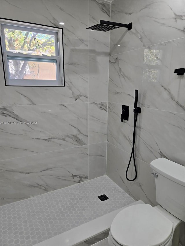 bathroom featuring toilet and a marble finish shower