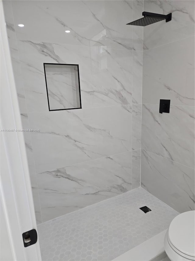 full bath featuring a marble finish shower and toilet