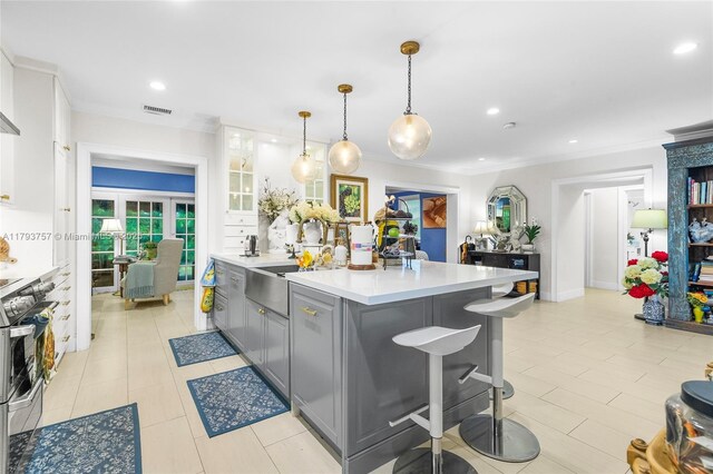 13101 SW 82nd Ave, Pinecrest, FL 33156 - kitchen with a sink, stainless steel stove, gray cabinets, crown molding, and light countertops