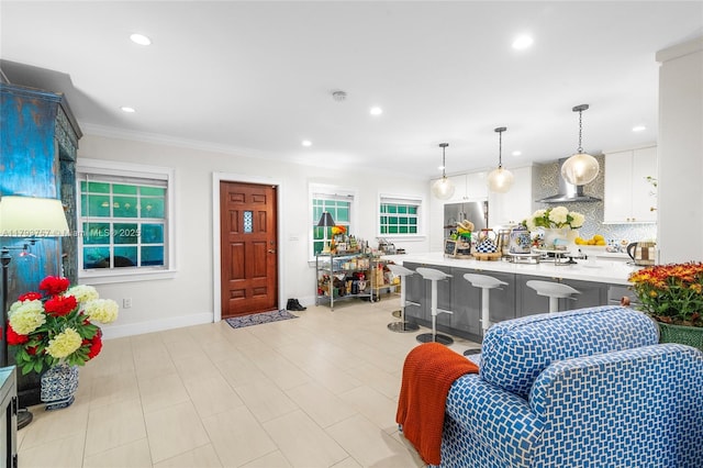 living room featuring crown molding, recessed lighting, and baseboards