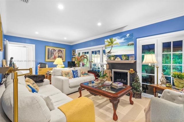 living room with crown molding, recessed lighting, french doors, and a fireplace
