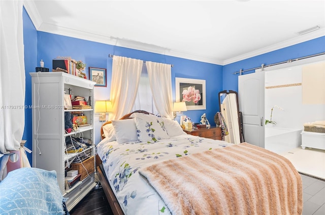 bedroom featuring visible vents, ornamental molding, and wood finished floors