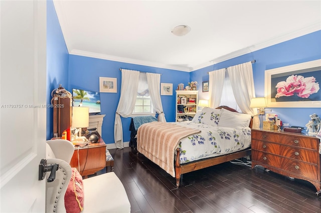 bedroom featuring baseboards, ornamental molding, and wood finished floors