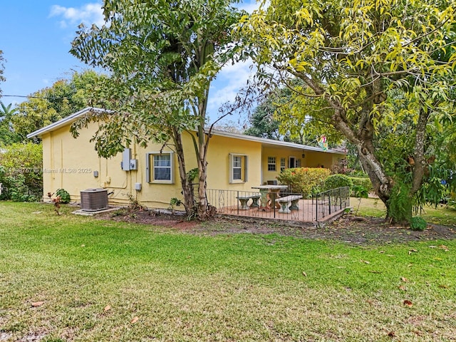 13101 SW 82nd Ave, Pinecrest, FL 33156 - back of house with stucco siding, a lawn, and a wooden deck