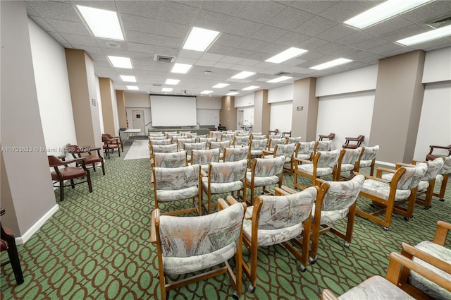 misc room with carpet floors, a drop ceiling, and visible vents