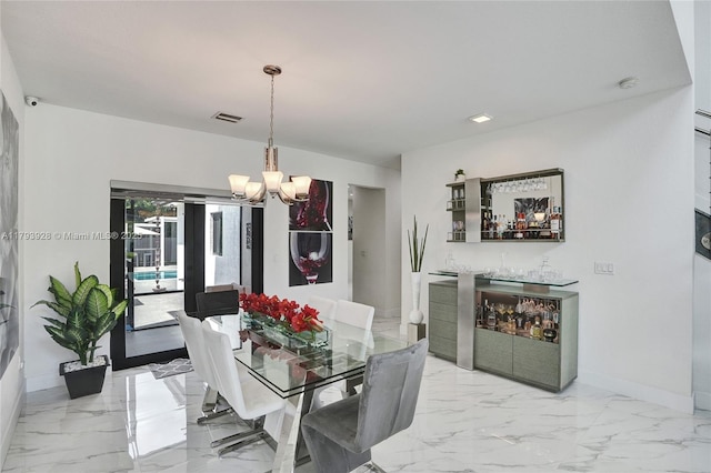 dining area with marble finish floor, baseboards, a notable chandelier, and visible vents