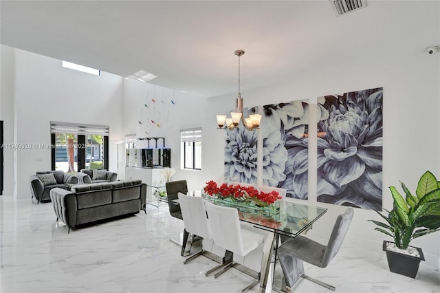 dining room with visible vents, marble finish floor, and a chandelier