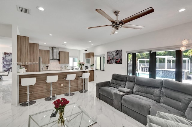 living room with recessed lighting, ceiling fan, visible vents, and marble finish floor