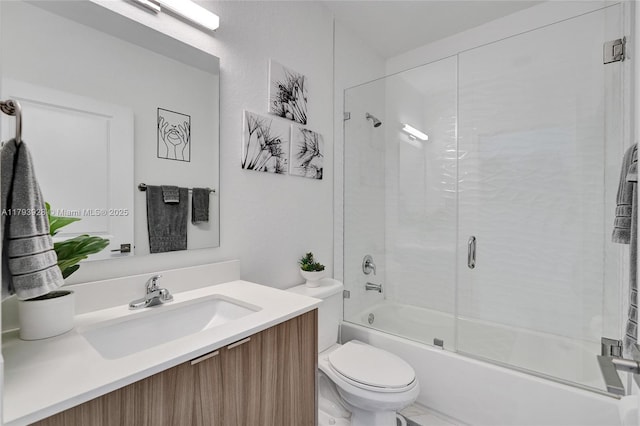 full bathroom featuring vanity, enclosed tub / shower combo, and toilet