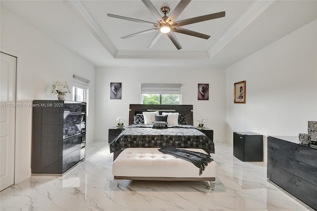 bedroom with marble finish floor, ceiling fan, ornamental molding, and a raised ceiling