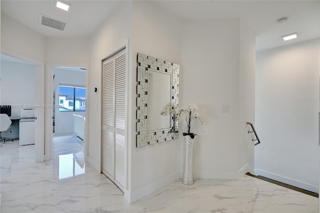 hall with baseboards, marble finish floor, and visible vents