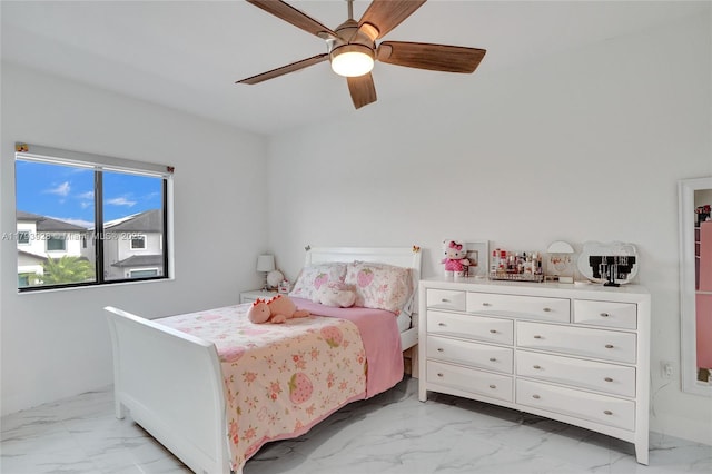 bedroom featuring a ceiling fan and marble finish floor