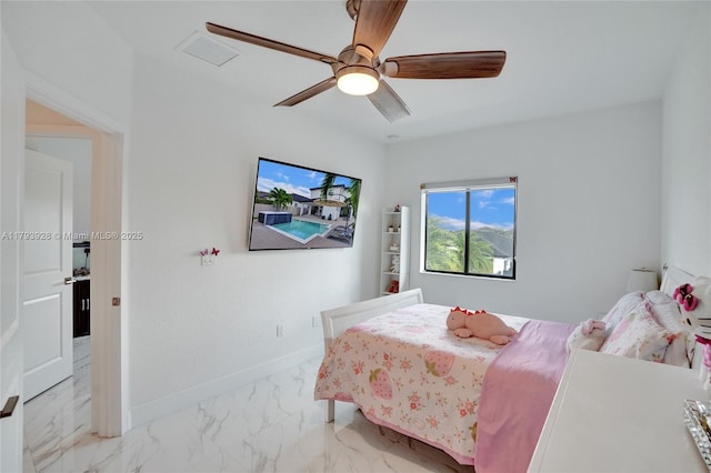 bedroom featuring baseboards, a ceiling fan, and marble finish floor
