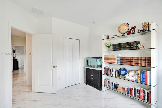 interior space featuring visible vents and marble finish floor