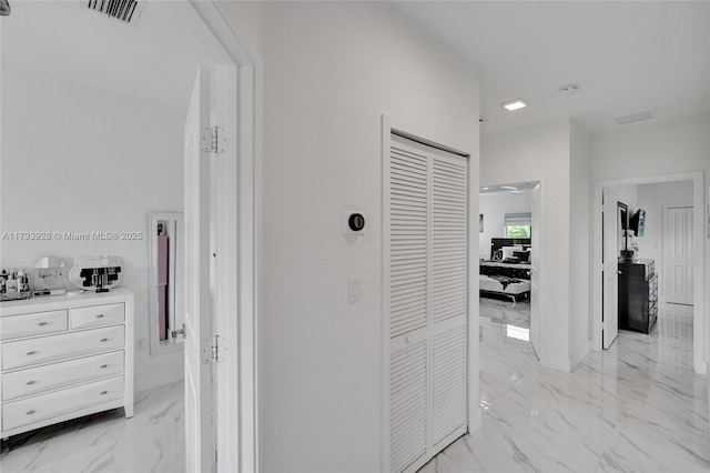 hall featuring visible vents and marble finish floor