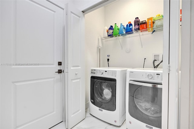 laundry room featuring laundry area, marble finish floor, and independent washer and dryer