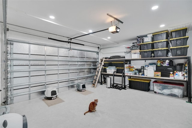 garage with a garage door opener and recessed lighting
